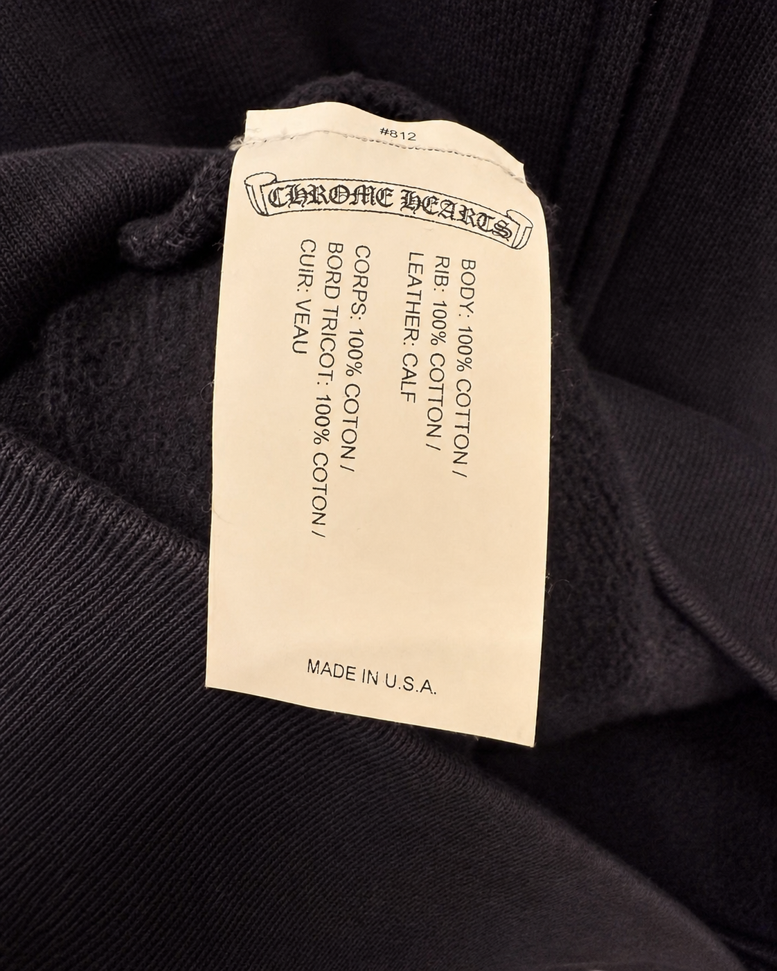 Designer archive cross leather patch and silver hardware detail

