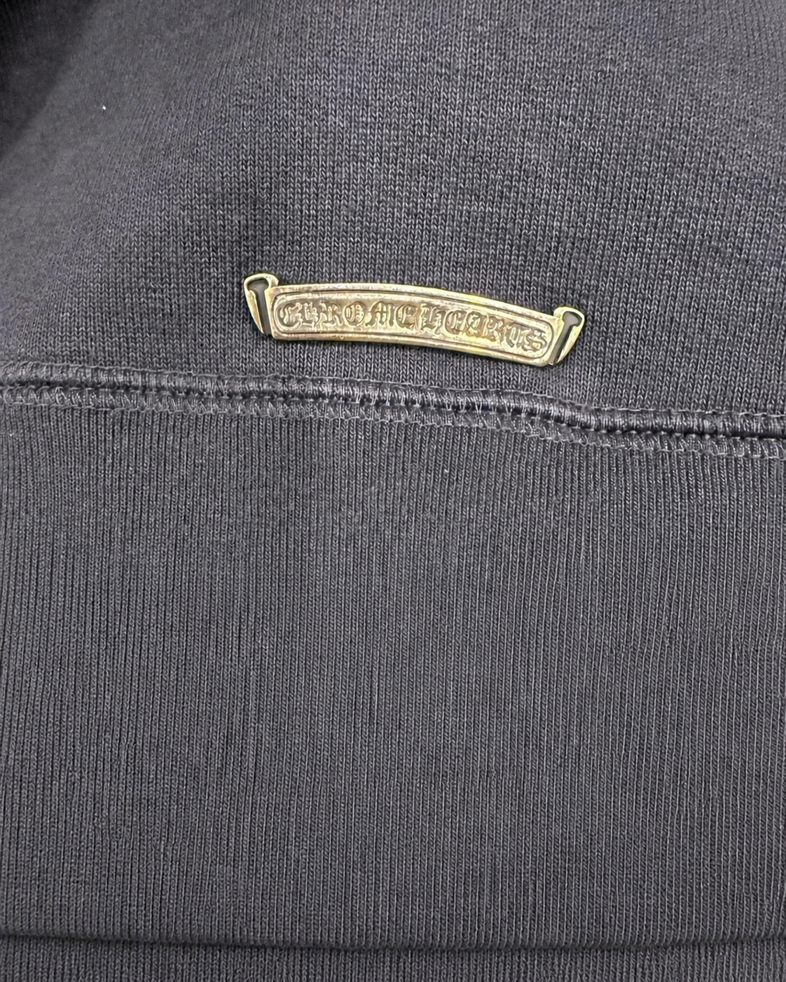 Designer archive red trident leather patch close-up detail